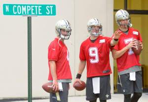 Advocate staff photo by MATTHEW HINTON--New Orleans Saints quarterback Drew Brees (9), center, sets up a throwing game with New Orleans Saints quarterback Ryan Griffin (4), left, and quarterback Luke McCown (7) practices at the Saints Training Facility in Metairie, La. Thursday, May 28, 2015.